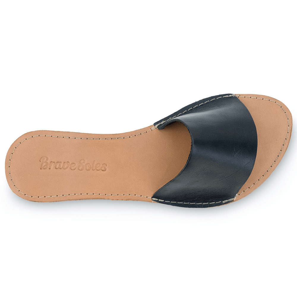 Top view of The Linda Women's Leather Slide Sandal in black and natural color, sustainably made by Brave Soles. 