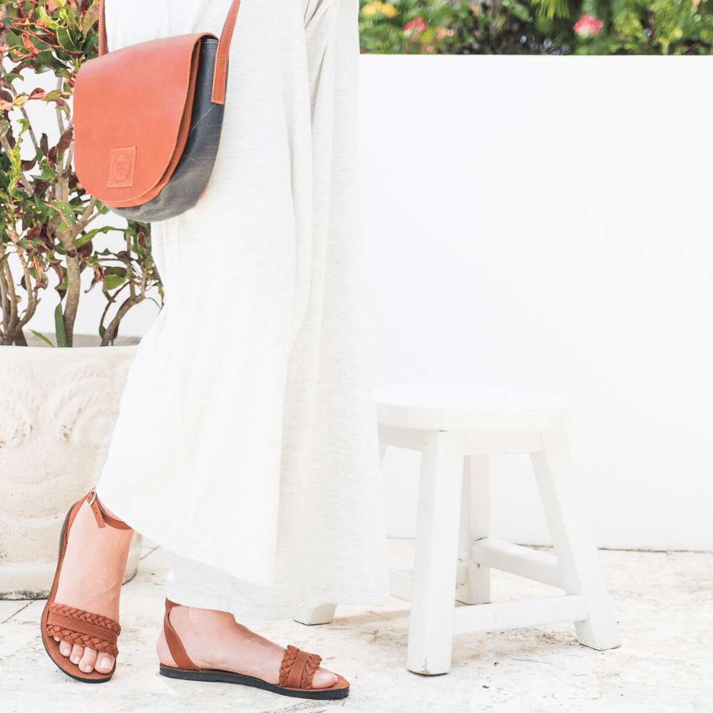 Female model wearing the Women's Bohemia leather sandals that are sustainably made by Brave Soles in caramel color