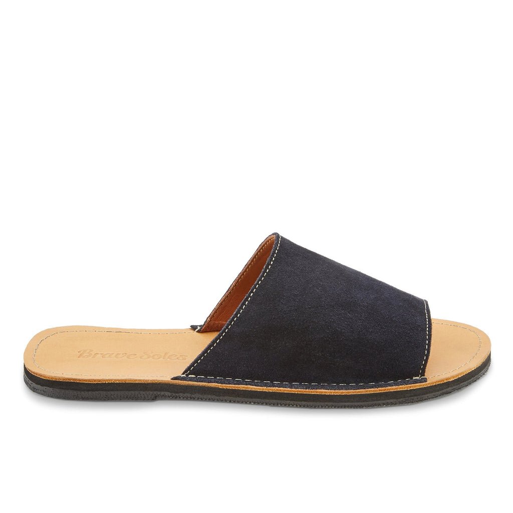 side view of the Oceana sustainably made leather slide sandal from Brave Soles in Navy and light brown color.